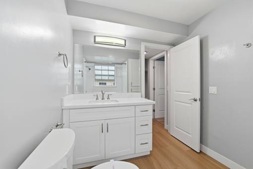 A white bathroom with a toilet, sink, and bathtub.