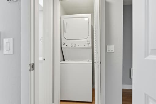 A white dryer is sitting in a doorway.