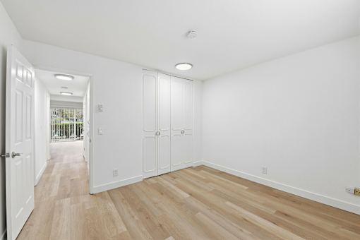 A room with white walls and wooden flooring.