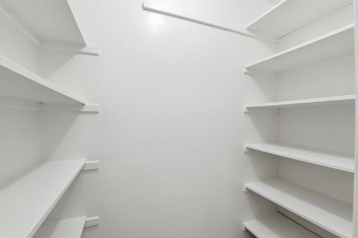 Empty white shelves in a room.