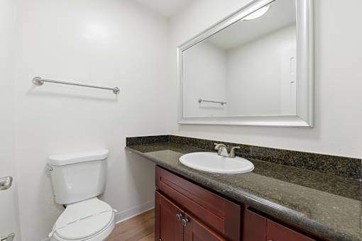 A white toilet sits next to a sink in a bathroom.