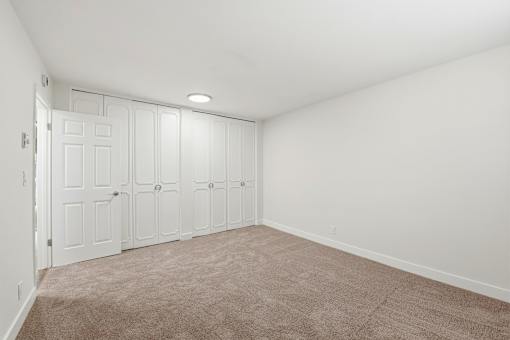 A room with white walls and a carpeted floor.