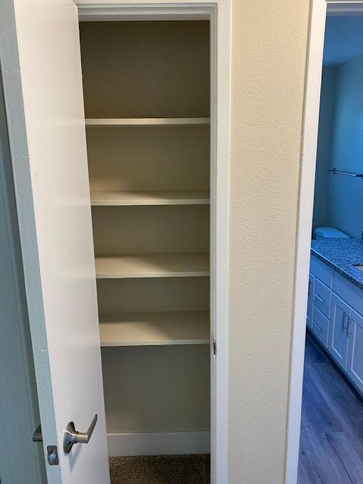 A white door with a silver handle is open.