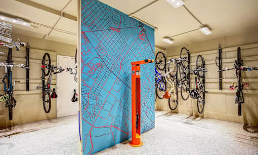a large blue wall with bikes hanging on it