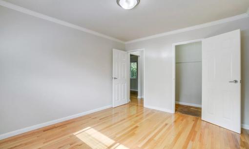 a room with three triangles on the walls and a wood floor