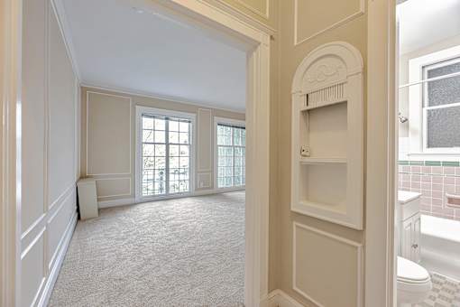 A white bathroom with a toilet and sink.