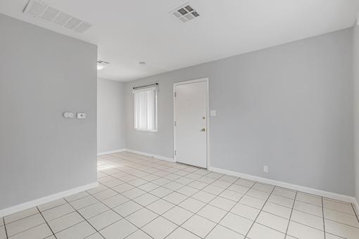 A room with white walls and a tiled floor.