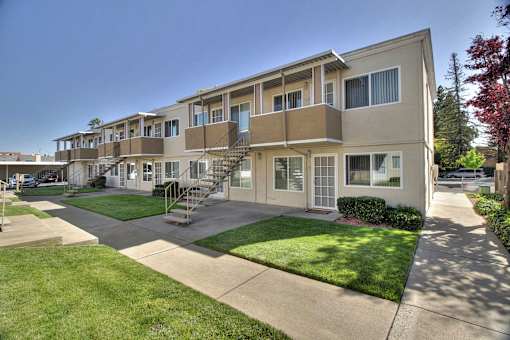 Apartment complex with a green lawn in front.