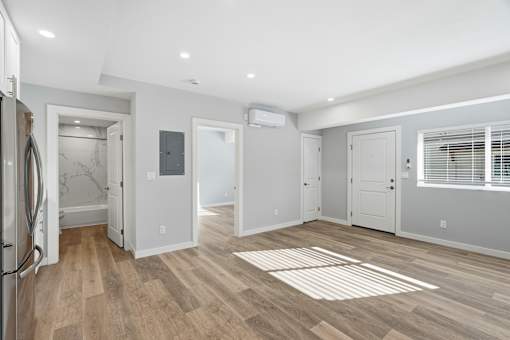 A kitchen with a refrigerator and a dining table.