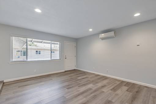 A room with a window and a door.