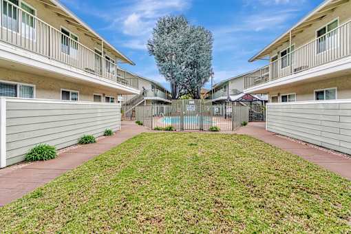 A grassy area in front of apartment buildings.