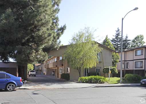 A blue car is parked on the side of a street.