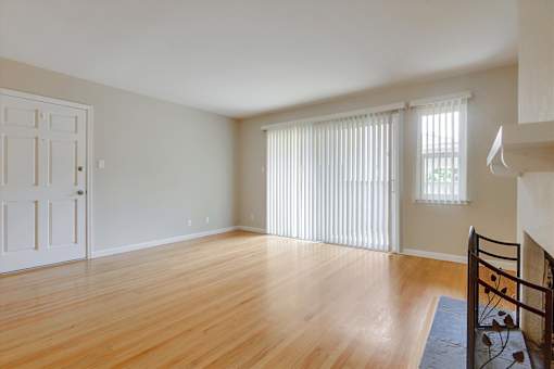 A room with wooden floors and a white door.