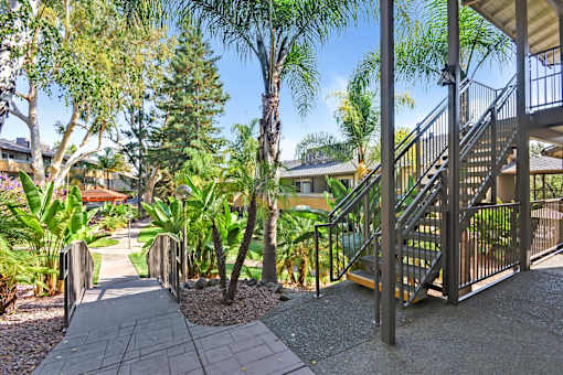 A staircase with a metal railing leads up to a building.