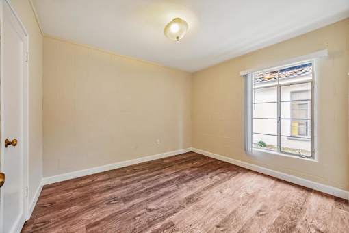 A room with a window and a door.