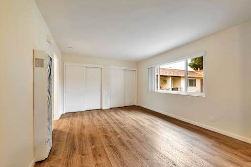 A room with wooden floors and white walls.