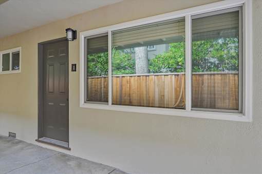 A brown wooden fence is seen through a window.