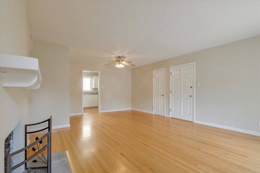 A room with wooden floors and white walls.