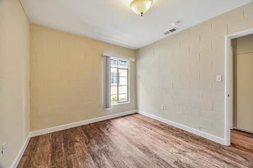 A room with wooden floors and a window.