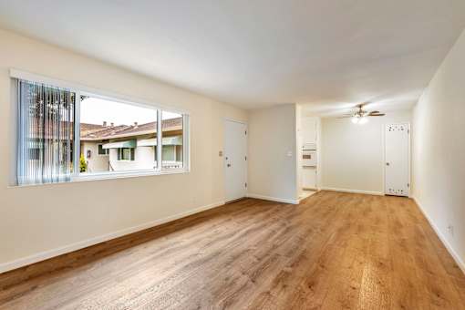 A room with wooden floors and white walls.