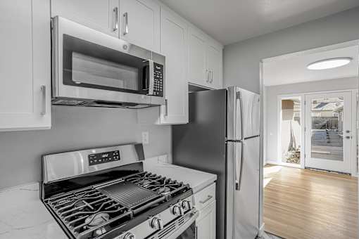 A modern kitchen with a black stove top oven and a black refrigerator.