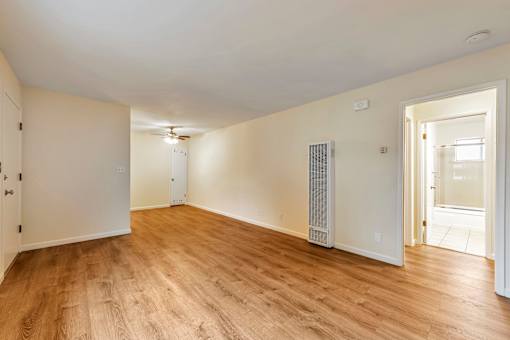 A room with wooden floors and white walls.