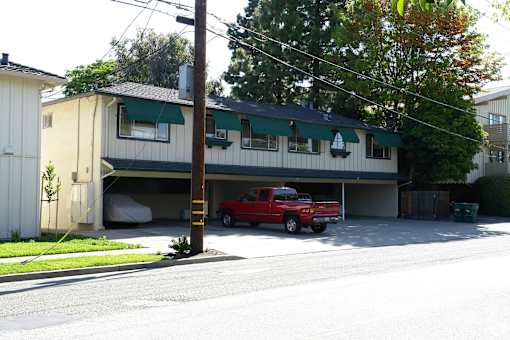 A red truck is parked in a garage.