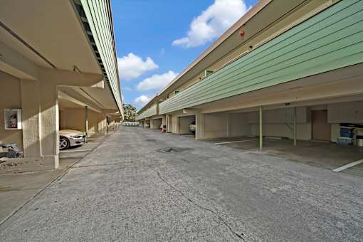 A parking lot with a car parked on the left side.