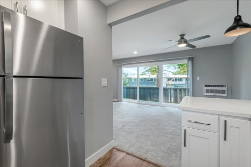 a kitchen with a stainless steel refrigerator and a window