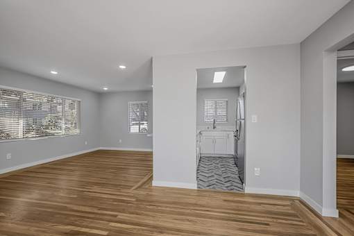 A room with wooden floors and white walls.