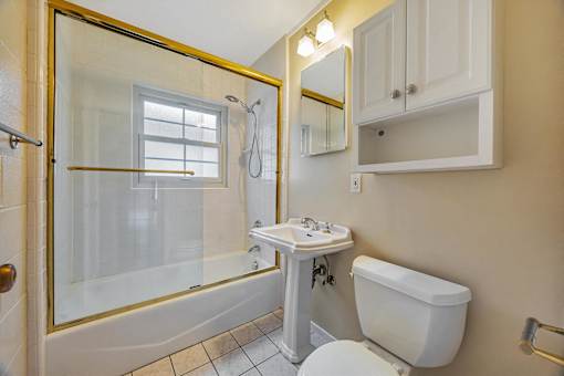 A white toilet sits next to a sink in a bathroom.