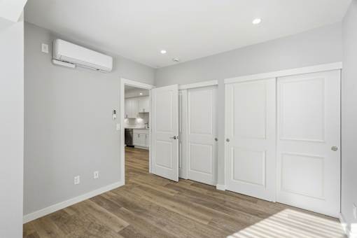 A room with a white door and a window.