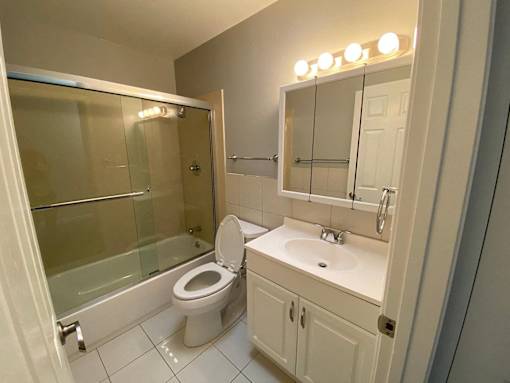 a bathroom with a urinal and a sink in it
