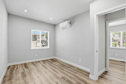 A room with a window and a door.