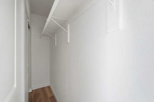 A white room with a wooden floor and white walls.