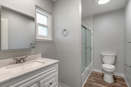 a bathroom with a toilet sink and a shower