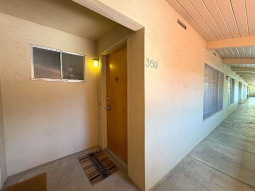 A hallway with a door numbered 359.