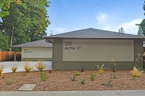 A small building with a sign that says 120 Alma St.