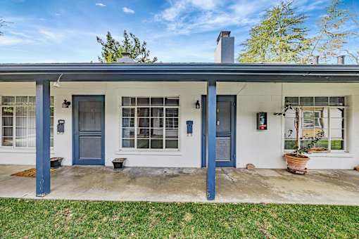 A house with blue doors and windows is shown.