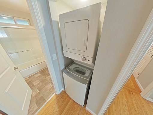A white washing machine is in a small laundry room.
