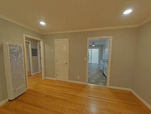 A room with wooden floors and white walls.