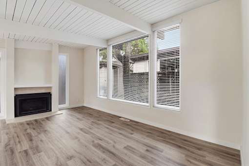A room with a fireplace and wooden floors.