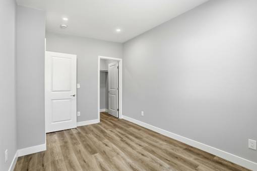 A room with a white door and a white wall.