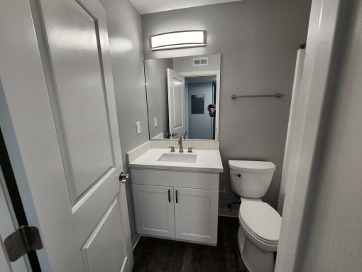 a small bathroom with a sink toilet and a mirror