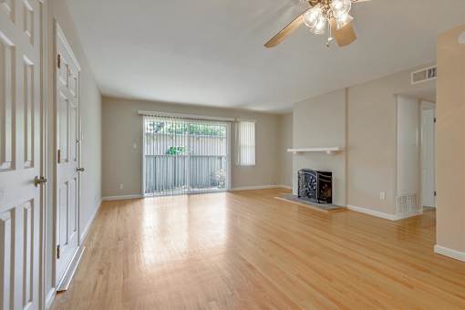 A room with a fireplace and a ceiling fan.
