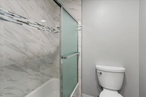 a bathroom with a toilet and a shower