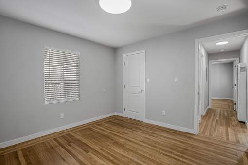 A room with wooden floors and white walls.