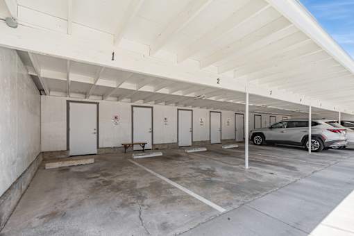 A parking garage with a car parked in the last spot.