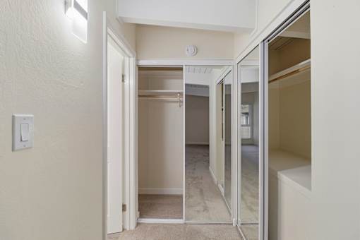 A white door is open to a hallway.