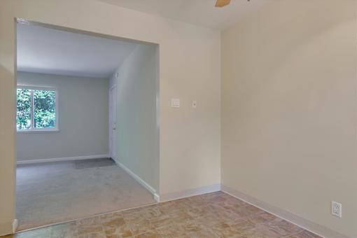 A room with a tiled floor and a window.